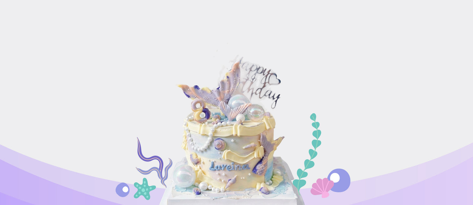 Mermaid themed birthday cake with pastel shells, pearls and ocean inspired decorations